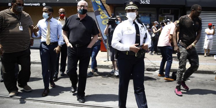 Philadelphia Police Commissioner Danielle Outlaw, center, and Mayor Jim Kenney, fourth from left, meet with people, Thursday, June 4, 2020, in Philadelphia after days of protest over the May 25 death of George Floyd, who died after being restrained by police in Minneapolis. 

Matt Rourke / AP Photo