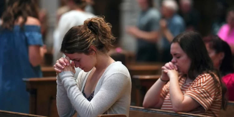 University of Pittsburgh student Olivia Meholic, front, prays after receiving Communion at St. Paul Catholic Cathedral in Pittsburgh on June 26. During the service, the Very Rev. Kris Stubna gave a homily focused on the Supreme Court's decision to overturn the nearly 50-year-old Roe v. Wade ruling, which he said was the result of prayers and efforts of many Catholics and others.

Jessie Wardarski / AP Photo