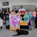 In the photo, from left to right, are: Kelly Lidgett, counselor; Michelle Ivicic, deputy superintendent; Joel Barrows, major; Scott Klinefelter, superintendent; Alicia Sager, counselor; and Mary Tatum, director. In front is Kirby.