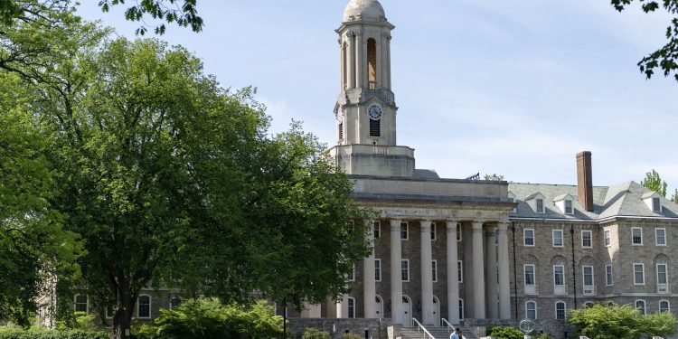 People walk across Old Main lawn on the Penn State campus on Wednesday, May 19, 2021.  

Abby Drey / Centre Daily Times