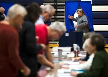 A voter steps from the voting booth Nov. 6, 2018, after casting his ballot in Doylestown, Penn.