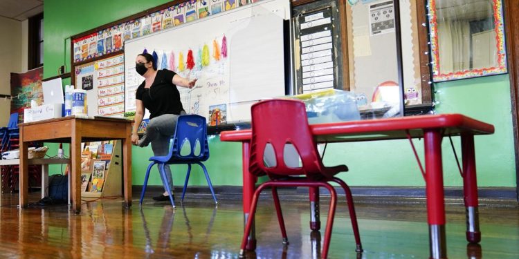 Teacher Tara Matise exercises with her prekindergarten students participating virtually in her classroom ahead of planned in-person learning at Nebinger Elementary School in Philadelphia in 2021.

Matt Rourke / AP Photo