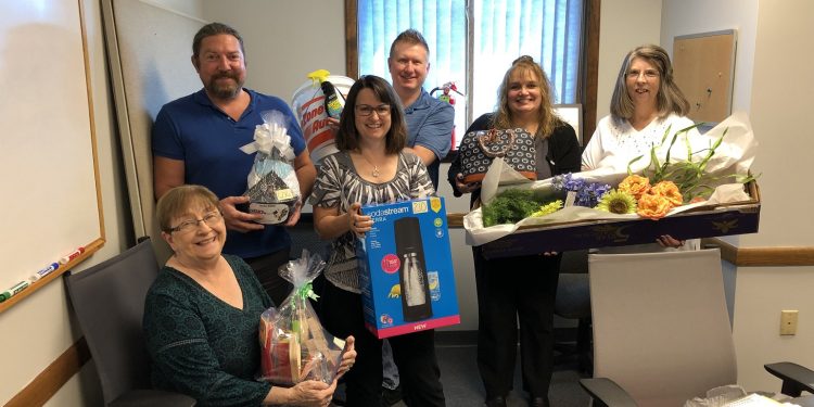 Members of the 2022 Ann S. Thacik Charity Auction with some auction items that have already been donated.  Left to right are Joan Bracco, Steve Harmic, Ronda Vaughn, Matt Day, Vicki Myers and Cathie Hugar.