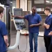 An engineer shows teen apprentices how to use a tool making machine.

Monkey Business Images / Shutterstock.com