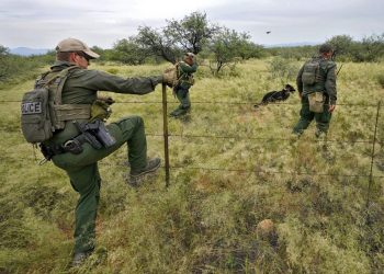 U.S. Border Patrol agents, aided by a dog and a Black Hawk helicopter, search for a group of migrants evading capture at the base of the Baboquivari Mountains on Sept. 8, 2022, near Sasabe, Ariz. The desert region located in the Tucson sector just north of Mexico is one of the deadliest stretches along the international border with rugged desert mountains, uneven topography, washes and triple-digit temperatures in the summer months. Border Patrol agents performed 3,000 rescues in the sector in the past 12 months.

Matt York / AP Photo