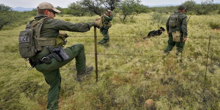 U.S. Border Patrol agents, aided by a dog and a Black Hawk helicopter, search for a group of migrants evading capture at the base of the Baboquivari Mountains on Sept. 8, 2022, near Sasabe, Ariz. The desert region located in the Tucson sector just north of Mexico is one of the deadliest stretches along the international border with rugged desert mountains, uneven topography, washes and triple-digit temperatures in the summer months. Border Patrol agents performed 3,000 rescues in the sector in the past 12 months.

Matt York / AP Photo