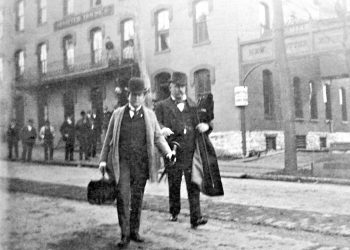 William Jennings Bryan (carrying satchel) leaving the Potter House Hotel on Presqueisle Street in Philipsburg to catch the train to Clearfield.