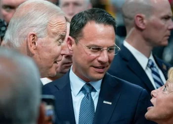 Pennsylvania Attorney General Josh Shapiro, center, and President Joe Biden talk July 28, 2021, with people at the Lehigh Valley operations facility for Mack Trucks in Macungie, Pa.

Susan Walsh / AP photo