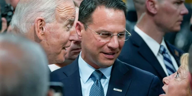 Pennsylvania Attorney General Josh Shapiro, center, and President Joe Biden talk July 28, 2021, with people at the Lehigh Valley operations facility for Mack Trucks in Macungie, Pa.

Susan Walsh / AP photo