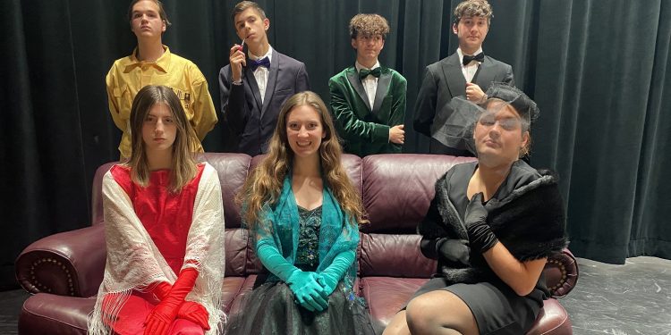 In front, from left, are:  Jaycee Wood (Miss Scarlet), Chloe Mallon (Mrs. Peacock) and Mason Marshall (Mrs. White). In the second row, from left, are:  Isaiah Snyder (Colonel Mustard), Ian Gibson (Professor Plum), Ethan Sorbera (Mr. Green) and Evan Forcey (Wadsworth)