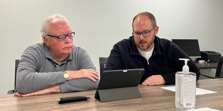 Dr. Richard Johnson, left, and Mature Resources Chief Operating Officer Ethen Tarner set up access for the doctor’s accounts at Susquehanna Wellness Clinic. Johnson will begin to see patients at the clinic in December.
