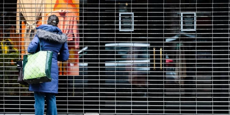 A person window shops at a closed business in Philadelphia, March 19, 2020. 

Matt Rourke / AP Photo