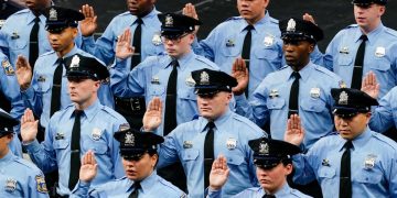 Members of the Philadelphia Police Academy Class #395 take the oath to become officers in Philadelphia, Friday, April 8, 2022.

Matt Rourke/AP Photo