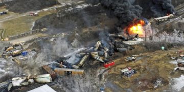 In this photo taken with a drone, portions of a Norfolk Southern freight train that derailed the previous night in East Palestine, Ohio, remain on fire at mid-day on Feb. 4, 2023. Transportation Secretary Pete Buttigieg announced a package of reforms to improve safety Tuesday, Feb. 21 — two days after he warned the railroad responsible for the derailment, Norfolk Southern, to fulfill its promises to clean up the mess just outside East Palestine, and help the town recover.

Gene J. Puskar | AP Photo