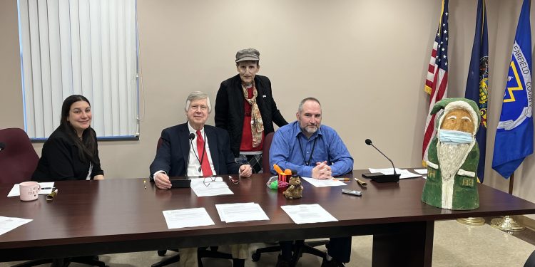 Pictured, in front from left to right, are Commissioners Mary Tatum, John A. Sobel, board chairman, and Dave Glass. In back is Jane Lee Yare, Hoodie Hoo Day event organizer. (Photo by GANT News Editor Jessica Shirey)