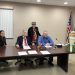 Pictured, in front from left to right, are Commissioners Mary Tatum, John A. Sobel, board chairman, and Dave Glass. In back is Jane Lee Yare, Hoodie Hoo Day event organizer. (Photo by GANT News Editor Jessica Shirey)