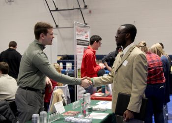 Kane Witter, right, shakes the hand of an employer representative during the career fair at Penn State DuBois in the PAW Center  Credit: Penn State