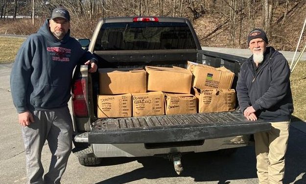 Jason Gill of the Country Butcher, left, presents MRAAA Facilities, Property, and Project Manager Jim Cutler with a donation of 300 pounds of packaged meat for consumers of the Mature Resources Area Agency on Aging.
