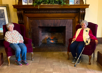 The longest-term resident of the Dimeling Senior Residence Carol Woods, right, can be seen with her friend Phyllis Bauman, left, most afternoons visiting with other residents in the lobby.