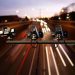 Speed camera monitoring busy traffic road at night.

Shutterstock