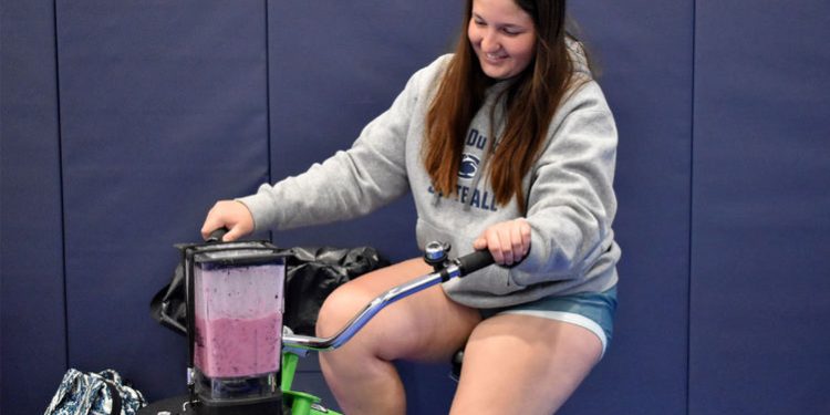Penn State DuBois sophomore Aleigha Geer pedals the smoothie bike to make her smoothie during the Earth Day celebration at the PAW Center

Credit: Penn State