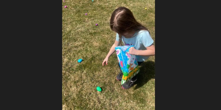 Kimber Butler, daughter of Dan Butler and Morgan McFarland, is shown as she finds eggs and fills her Easter bag.