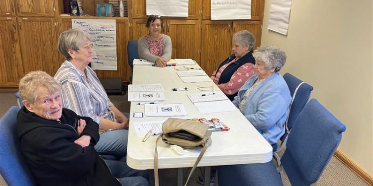 Health and Wellness Coordinator Bobbie Johnson, at center, leads a group of Health and Wellness program participants in an introduction to the Matter of Balance program.  At left, front to back, are Mary Kay Yarger and Janet Bietz. At right, front to back, are Phyllis Bauman and Nancy Lanich.