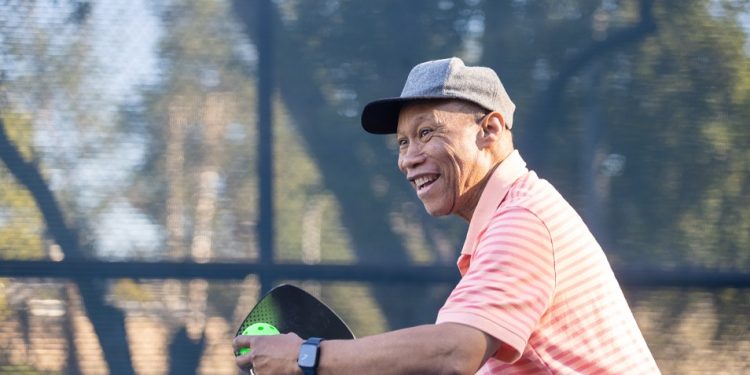 A senior black couple playing pickleball