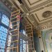 Rob Wozniak from Preservation Works of Easton, Pa., inspects original plasterwork in the coffee shop space at the Dimeling Hotel.