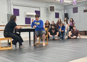 Melchior (Jack Danko) and Moritz (Dominik Barnyak) share a moment in the upcoming production of Spring Awakening with cast members looking on (row 1 l to r) Noah Webb, Austin McDanel, Phillip Peters, (row 2 l to r) Jenna Bowman, Alexis Hahn, Emily Switala, Elise DuFour, and Alexa Trimbur. Missing from photo: Jillian Bruni-Crytser, Mason Marshall, Kathleen Ammerman, and Stephen Torquato.