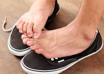 Man scratching his athlete's foot.Close up.