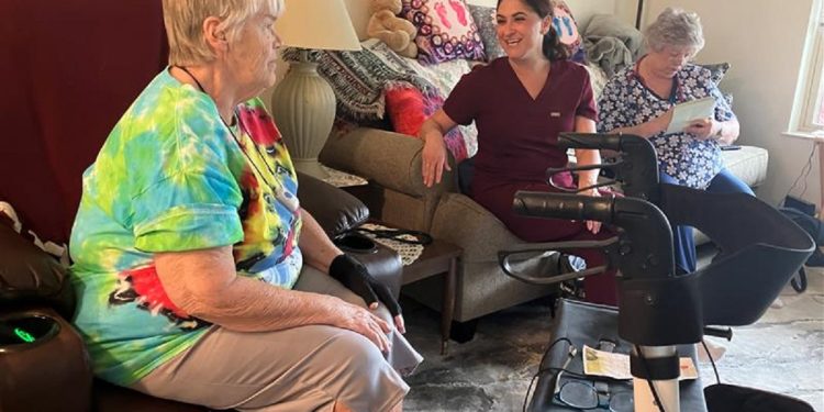From left, patient Margaret Beveridge, Dr. Jessica Ayres, and RN Sandra Turner discuss treatment options for Margaret’s knee injury during a recent in-home doctor’s visit.
