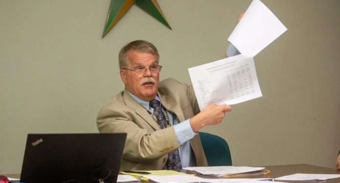 Commissioner Scott North displays an audit received by PAGO to the attendees of the meeting. (ExploreJeffersonPA)