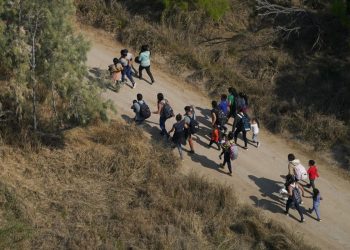 Migrants walk on a dirt road after crossing the U.S.-Mexico border, Tuesday, March 23, 2021, in Mission, Texas.

Julio Cortez / AP Photo