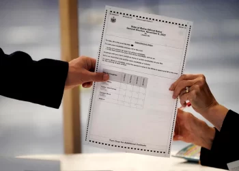 A ballot showing the choices for Maine's 2nd Congressional District is handed to a voter, Tuesday, Nov. 8, 2022, in Lewiston, Maine. The state's ranked choice voting system will likely be used to determine the winner in a close race between incumbent Democrat Jared Golden and Republican Bruce Poliquin.

Robert F. Bukaty | AP