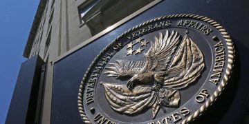 This is the seal affixed to the front of the Department of Veterans Affairs building in Washington. The federal government wrote duplicate checks to doctors who provided care for veterans, costing taxpayers $128 million in extra payments over the last five years, according to a new watchdog report out this week. In nearly 300,000 cases, private doctors were paid twice – once by the Veterans Health Administration and another time by Medicare – for the same care provided to veterans from 2017 to 2021, the Health and Human Services Office of Inspector General found in its report. (AP Photo/Charles Dharapak, File)