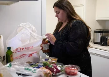 Jaqueline Benitez puts away groceries at her home in Bellflower, Calif., on Monday, Feb. 13, 2023. Benitez, 21, who works as a preschool teacher, depends on California's SNAP benefits to help pay for food.

AP Photo/Allison Dinner