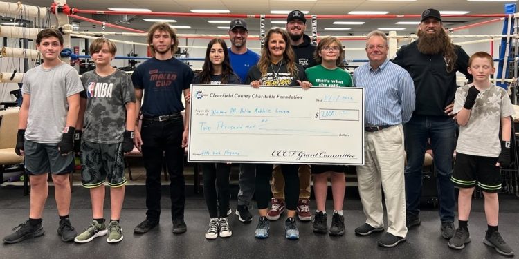 CCCF Executive Director Mark McCracken presents a 2022 CCCF Grant Award to Western PA Police Athletic League.  Organizations may begin filing online applications for 2023 grants on Monday August 7th. PICTURED L-R Jaidyn Pollnac, Masin Lundholm, Cooper Harris, Aviana Gillaugh, Gregg Gillaugh, Kristy Murphy, Gage Resch, Colton Edwards, Mark McCracken, Aaron Beatty and Holdin Lundholm.