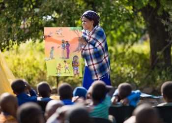 Children sit at attention while a ministry partner shares the Gospel at an outreach event in Botswana. (Photo is courtesy of Samaritan’s Purse)
