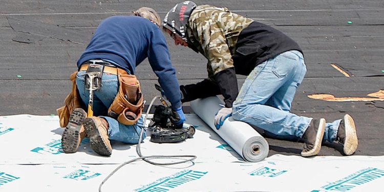 Roofers repair a roof April 16, 2020, in Harmony, Pennsylvania.

Keith Srakocic | AP Photo