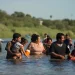 Migrants navigate around concertina wire along the banks of the Rio Grande after crossing from Mexico into the U.S., Tuesday, Aug. 1, 2023, in Eagle Pass, Texas. Concertina wire and newly place buoys being used as a floating barrier, are making in more difficult and dangerous to cross the Rio Grande. 

Eric Gay | AP