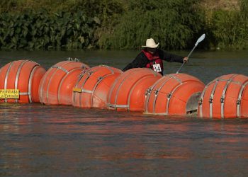 A kayaker passes large buoys being used as a floating border barrier on the Rio Grande Tuesday, Aug. 1, 2023, in Eagle Pass, Texas.

Eric Gay | AP