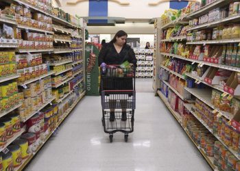 Jaqueline Benitez pushes her cart down an aisle as she shops for groceries at a supermarket in Bellflower, Calif., on Monday, Feb. 13, 2023. Benitez, 21, who works as a preschool teacher, depends on California's SNAP benefits to help pay for food.

Allison Dinner | AP