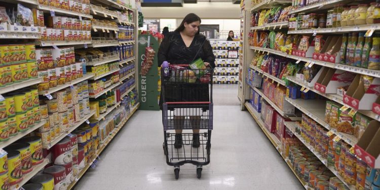 Jaqueline Benitez pushes her cart down an aisle as she shops for groceries at a supermarket in Bellflower, Calif., on Monday, Feb. 13, 2023. Benitez, 21, who works as a preschool teacher, depends on California's SNAP benefits to help pay for food.

Allison Dinner | AP