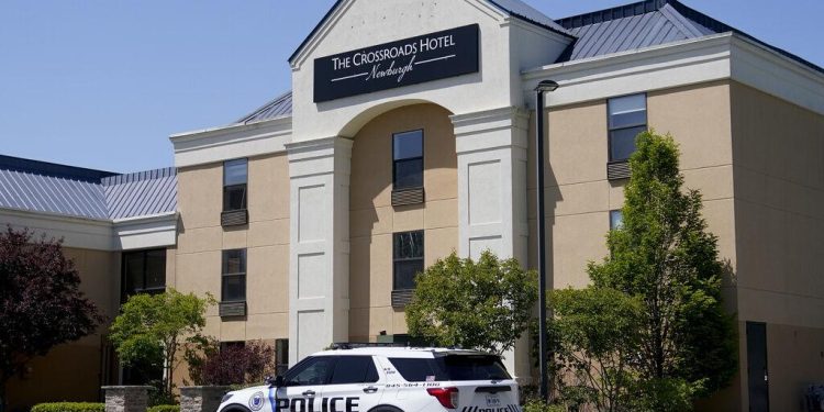 FILE - A Town of Newburgh police vehicle sits parked outside The Crossroads Hotel, where two busloads of migrants arrived hours earlier, on May 11, 2023, in Newburgh, N.Y. 

John Minchillo / AP Photos