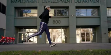 In his Dec. 18, 2020 file photo a runner passes the office of the California Employment Development Department in Sacramento, Calif. 

Rich Pedroncelli / AP Photo