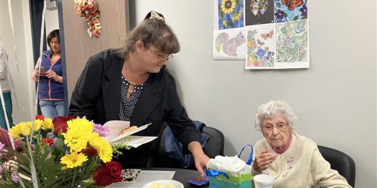 Mary McCormick (center) leads daily activities for consumers at the Adult Day Center. Recently the center hosted a party for Josephine Calapa’s (right) 97th birthday.