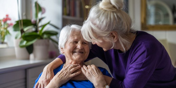 Woman hugging her elderly mother