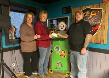 Pictured from left to right:  Teena Schelebo, owner of Mary's Place; Ida Evans, Coach's sister; and Lou Lusk, Ambassador for PA Wounded Warrior's Inc., Camp Hill, PA.
