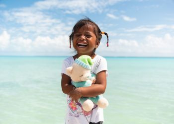 A girl from Kiribati loves the new “wow” toy she found in her shoebox gift. (Photo is courtesy of Samaritan’s Purse)